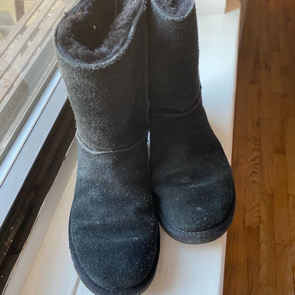 Short black UGG boots with back zipper.